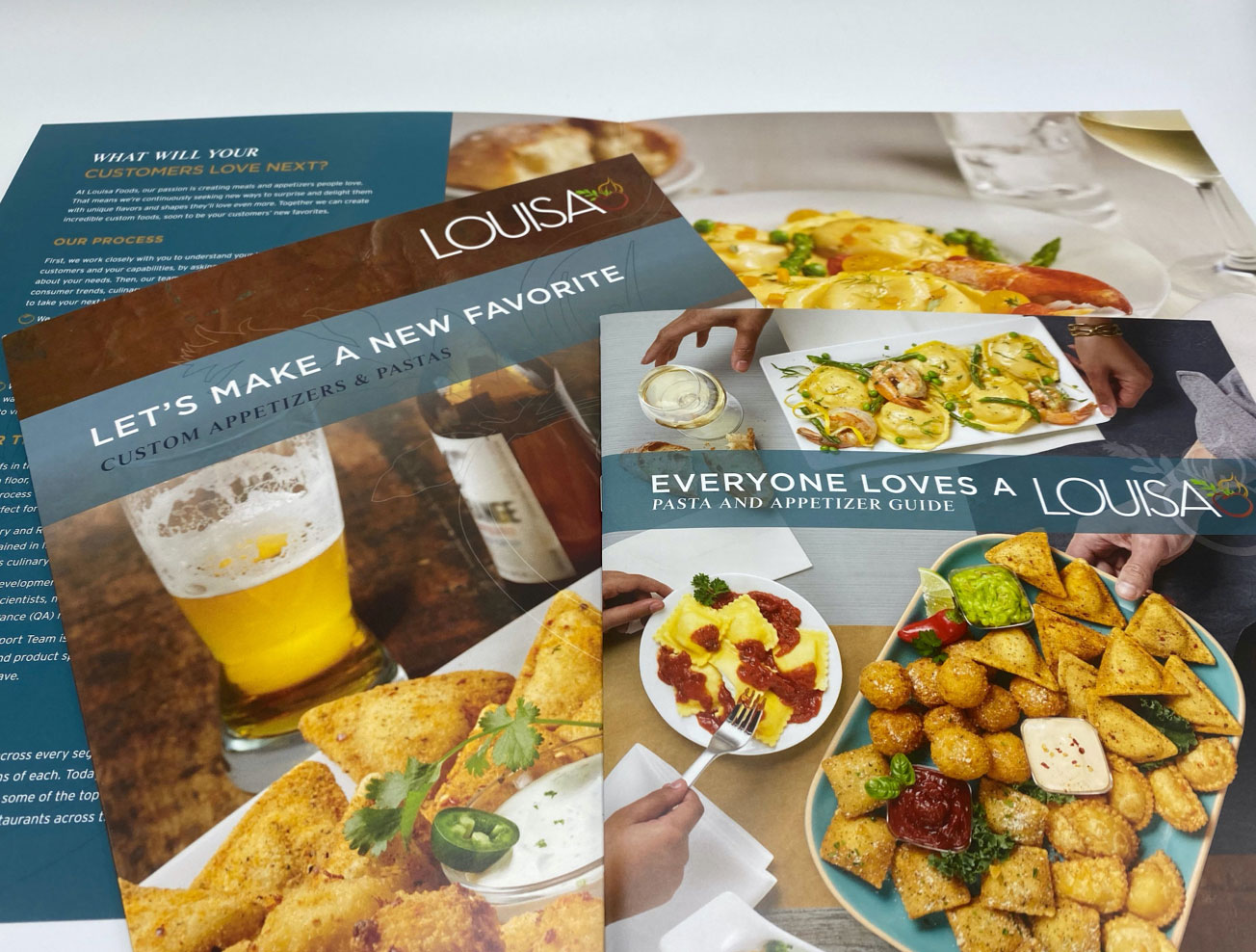Louisa Foodservice brochures spread out on a table